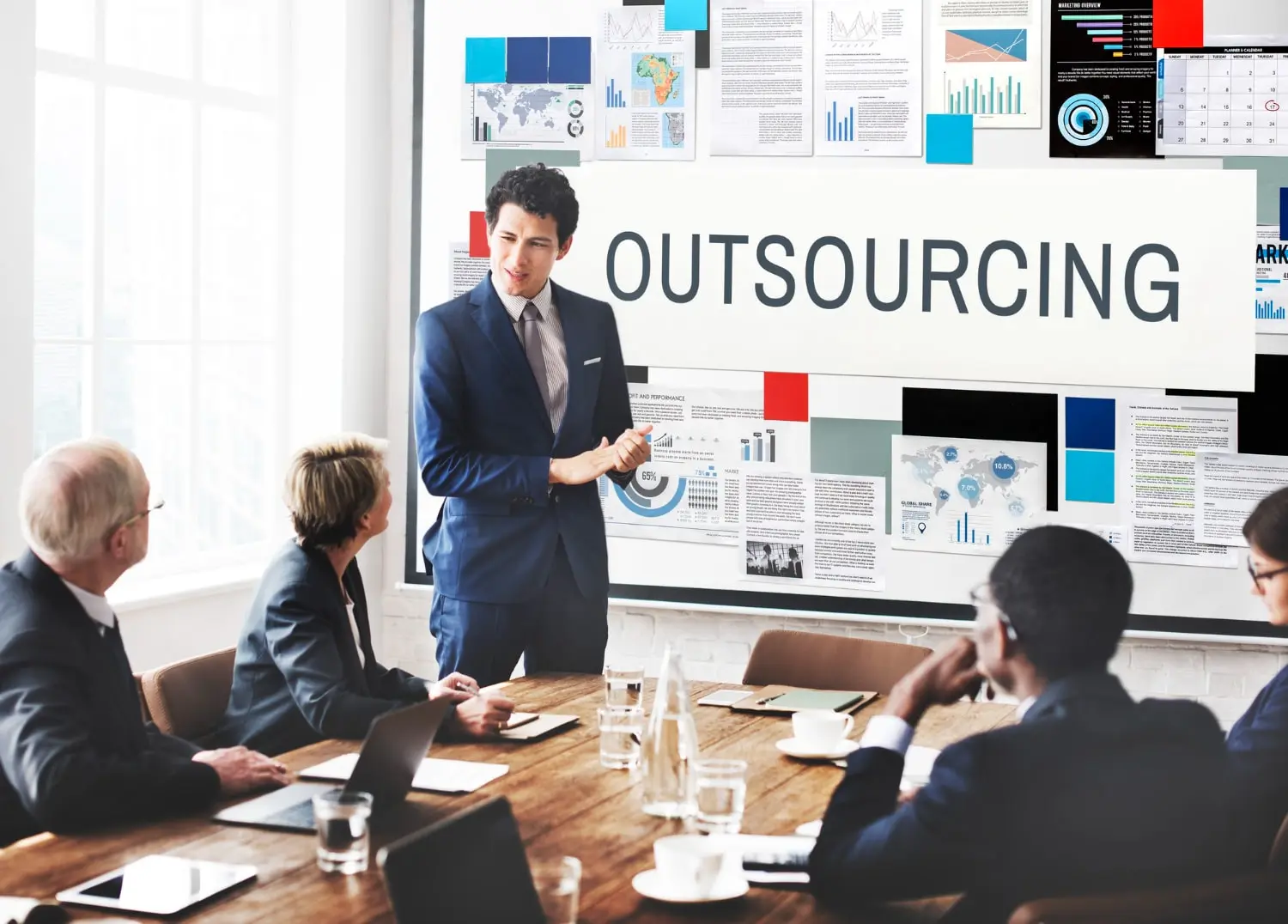 A business manager explaining the team the benefits of Outsourcing Accounts Receivable